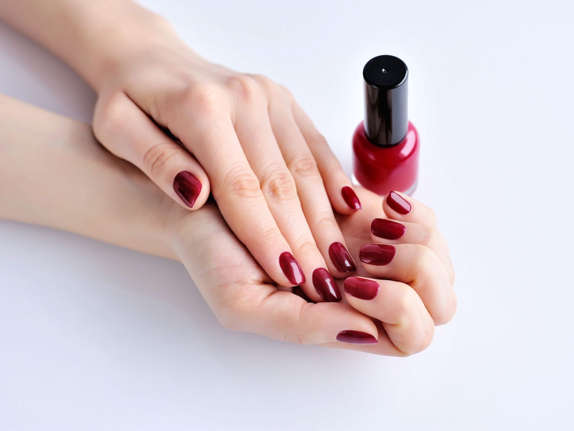 hands-of-a-woman-with-dark-red-manicure-and-nail-P5VNS4S.jpg