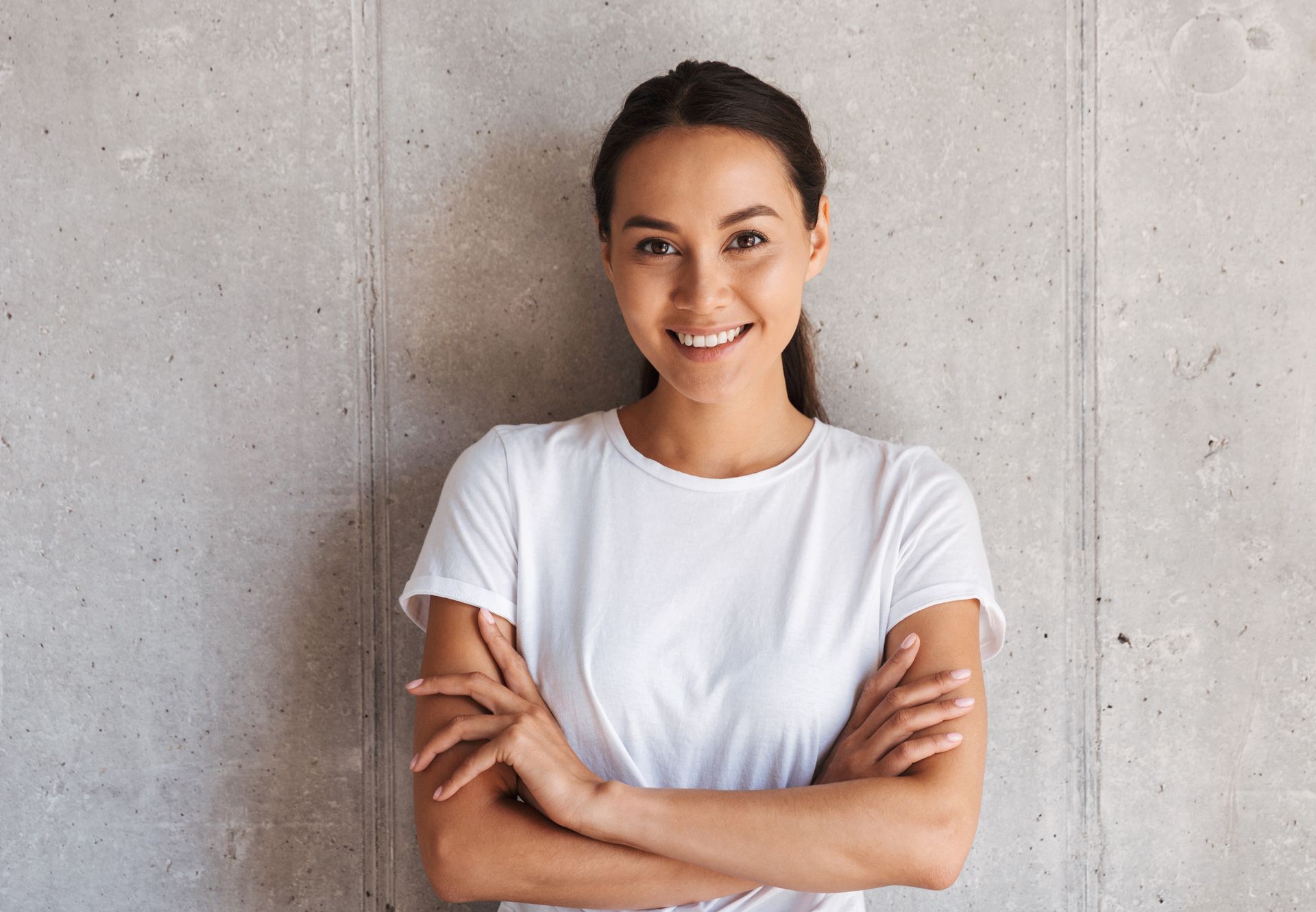 smiling-young-asian-woman-standing-with-arms-MXBNFDU.jpg